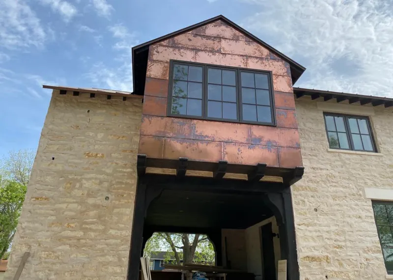 Copper metal panel facade on a stone building for Roof Repair in Rossmoor